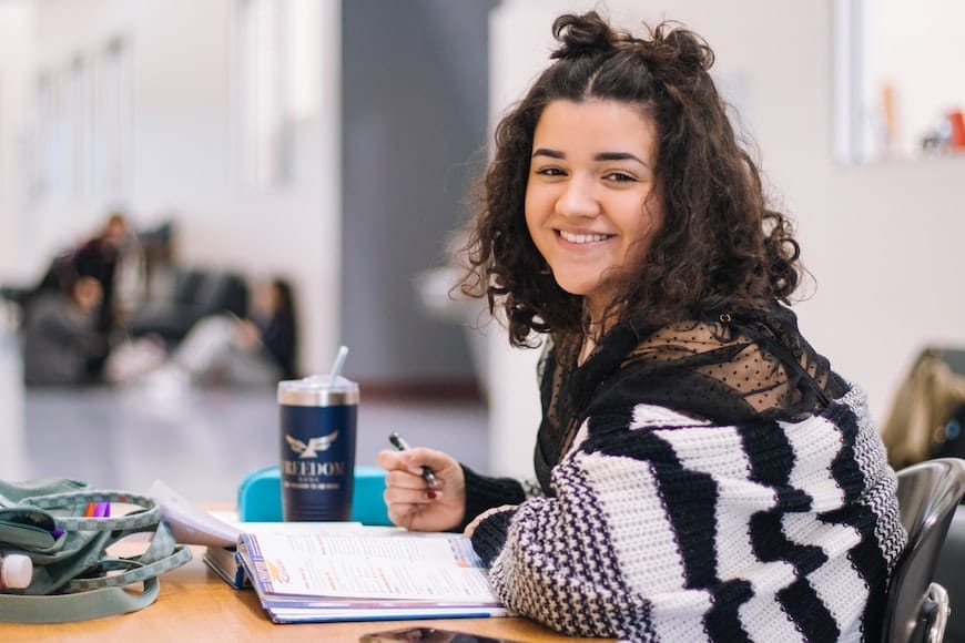 Woman looking at sticky notes on a wall with potential career ideas written on them